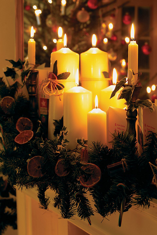 White candles in a green wreath